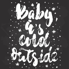 Baby, its cold outside - hand drawn Christmas and New Year winter holidays lettering quote isolated on the black chalkboard background. Fun brush ink inscription for greeting card or poster design.