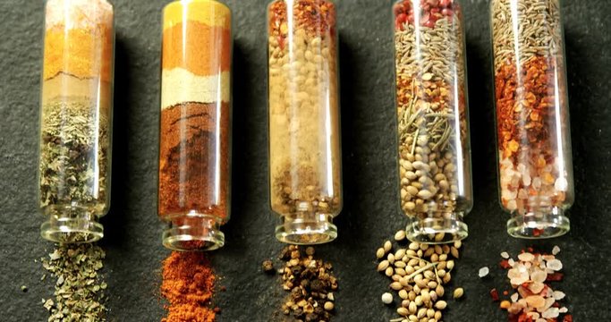Various spices spilled out of jar 