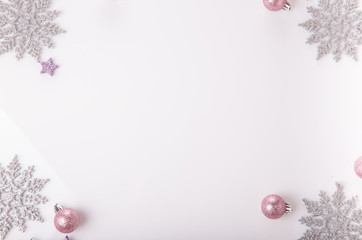 Christmas holiday composition. Festive creative gold silver pattern, xmas pink decor holiday ball with ribbon, snowflakes on white background. Flat lay, top view