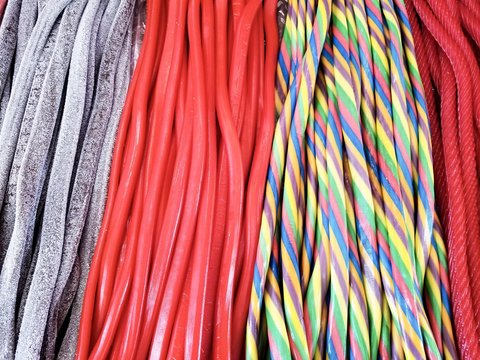 background of rainbow twisted candy. colorful twisted licorice candy, texture