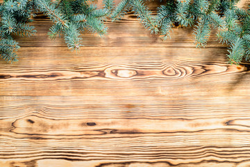 Christmas composition. Fir branches on wooden background with copyspace for text. Top view, flat