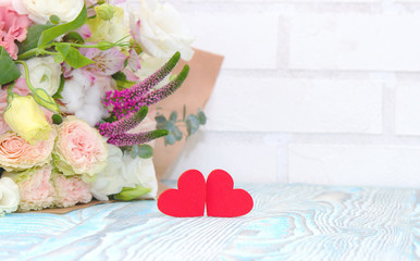Valentine's Day. Valentine Gift. Red Hearts and bouquet of flowers on blue wooden background. Beautiful Valentine card art design