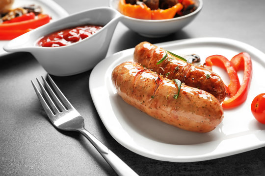 Grilled sausages served on plate with vegetables