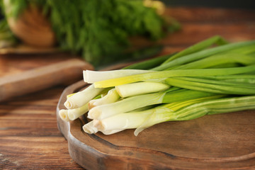 Fresh green onion on wooden table