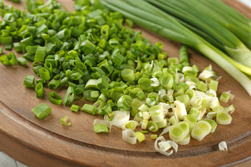 Fresh green onion on wooden board