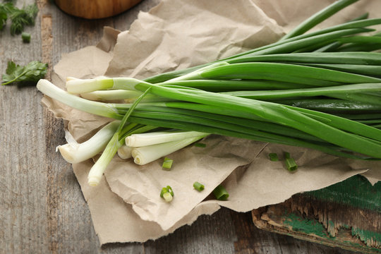Fresh green onion on wooden table