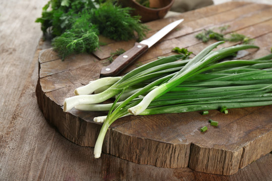 Fresh green onion on wooden table