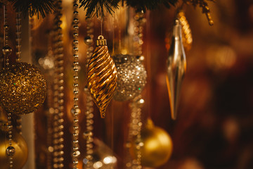 Christmas Baubles hanging with lighting stars in the background.