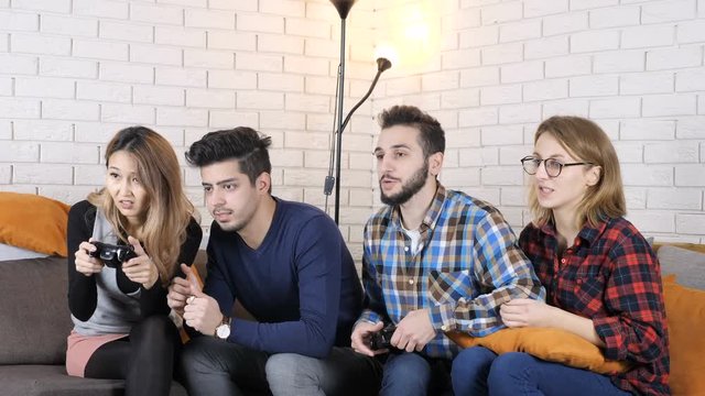 Multinational company sit on the couch, boys playing versus girls 50 fps
