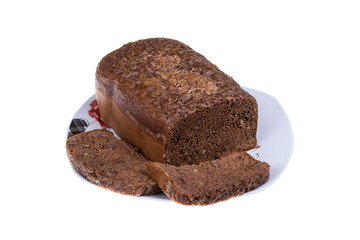 Homemade cocoa cake with walnuts and raisins baked in bread maker isolated on white background.