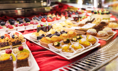 Tasty beautiful cakes on a show-window in cafe