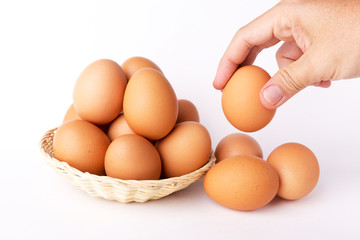 Eggs in the basket with hand.