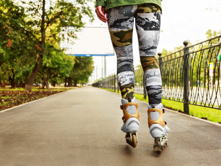 Young woman on roller skates in the park