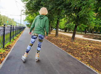 Young woman on roller skates in the park