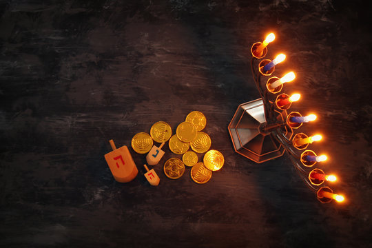 jewish holiday Hanukkah background with traditional spinnig top, menorah (traditional candelabra) and burning candles