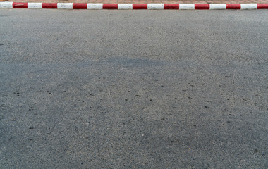 Road with red and white curb