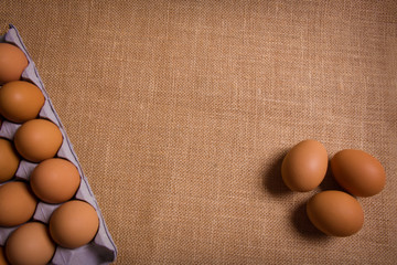 Fresh organic panel eggs on sackcloth with copy space for text