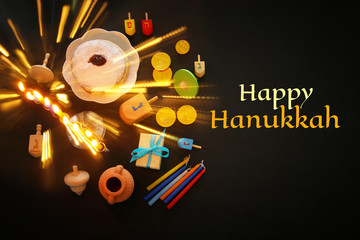 Top view image of jewish holiday Hanukkah background with traditional spinnig top, menorah (traditional candelabra) © tomertu