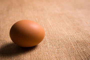 Fresh organic egg on sackcloth(gunny) with copy space for text