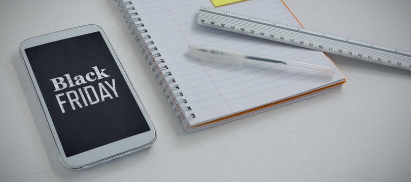 Composite image of mobile phone and stationery on white