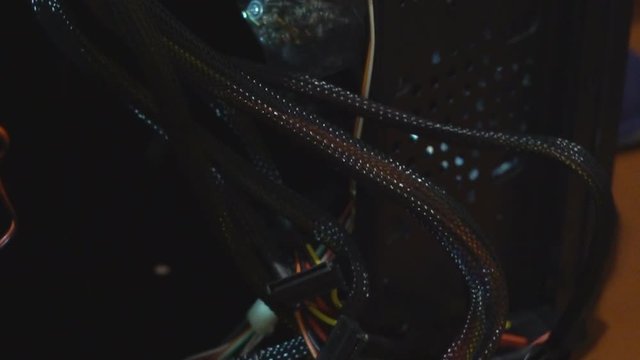 the system unit of the stationary computer is dismantled. A broken computer with wires. damaged hackor virus server. 4k