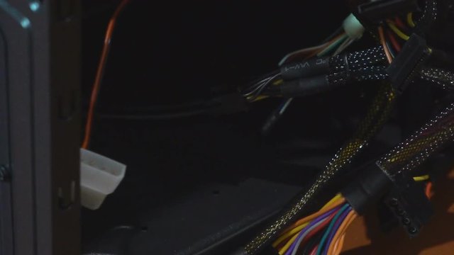 the system unit of the stationary computer is dismantled. A broken computer with wires. damaged hackor virus server. 4k