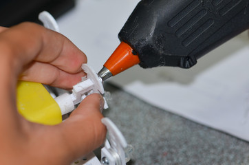 Men are using hot glue to the device.
