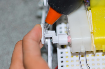 Men are using hot glue to the device.