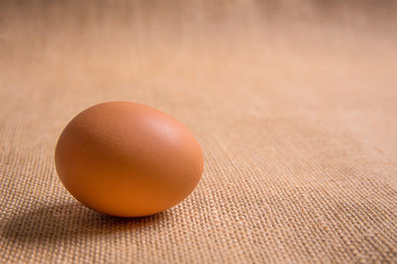 Fresh organic egg on sackcloth(gunny) with copy space for text