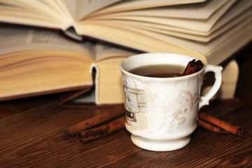 A Cup of coffee, cinnamon sticks and old books