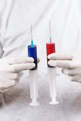 Hand with syringes, ready for narcotic injection