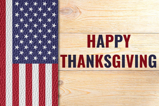 happy thanksgiving, greeting card with us flag on wooden table