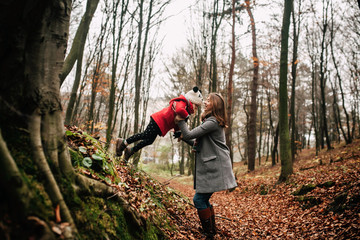 mother and daughter walking in the woods. family concept