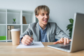 smiling businessman working at laptop