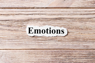 EMOTIONS of the word on paper. concept. Words of EMOTIONS on a wooden background