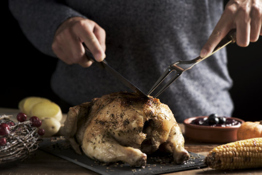 young man carving a roast turkey