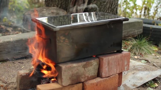 smokehouse for homemade  hot smoked on fire, traditional cooking  fish, alder smoke