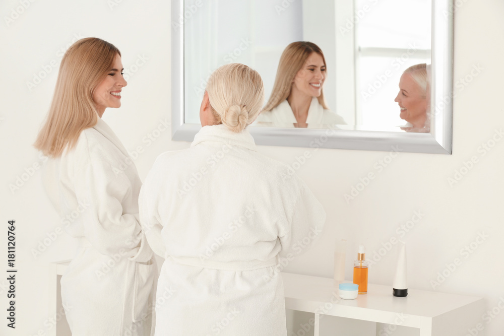 Wall mural Mature woman with daughter in bathroom