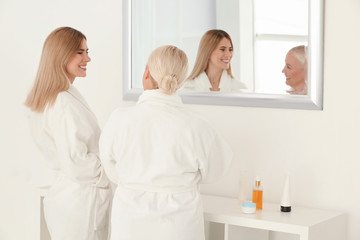 Mature woman with daughter in bathroom