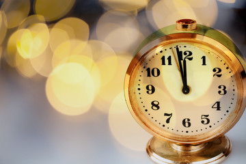 Fototapeta na wymiar new Year's at midnight - clock at twelve o'clock with holiday lights
