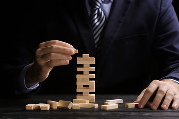 Young man with jenga at table © Africa Studio
