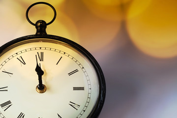 new Year's at midnight - clock at twelve o'clock with holiday lights