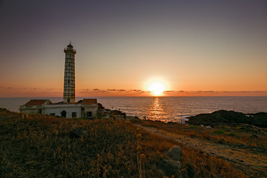 Seascape with lighthouse and sunset at sunset on Ustica island in Meditteraneo,