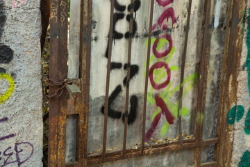 Old rusty door with graffiti