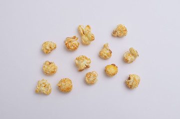 Popcorn on green background. Top view. Flat lay pattern.