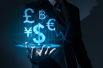 The abstract image of the business man hold the virtual hologram on hand. The concept of currency, financial, online, businessman, information technology and internet of things.