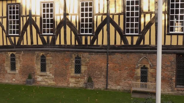 Panning shot of medieval guildhall building wall,The Merchant Adventurers' Hall, in the centre center of  old English town of York