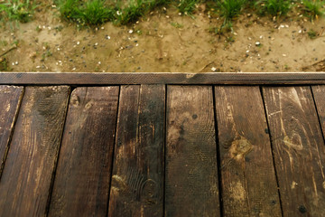 Empty wooden table with garden bokeh for a catering or food background with a country outdoor theme,Template mock up for display of product