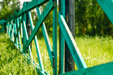 Old wooden fence and gate in green, grass landscape of Mongolia