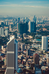 Fototapeta premium Modern architecture, business office building, cityscape background. Kuala Lumpur skyline. Travel to Malaysia. Urban skyscrapers. Modern city. Financial district. Aerial view of downtown. Vertical